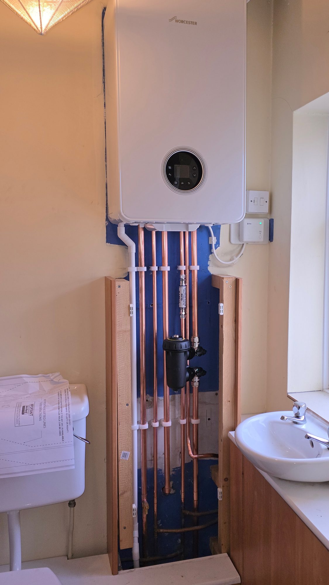 Worcester boiler installation in a bathroom with magnetic system filter and scale reducer on new copper pipework