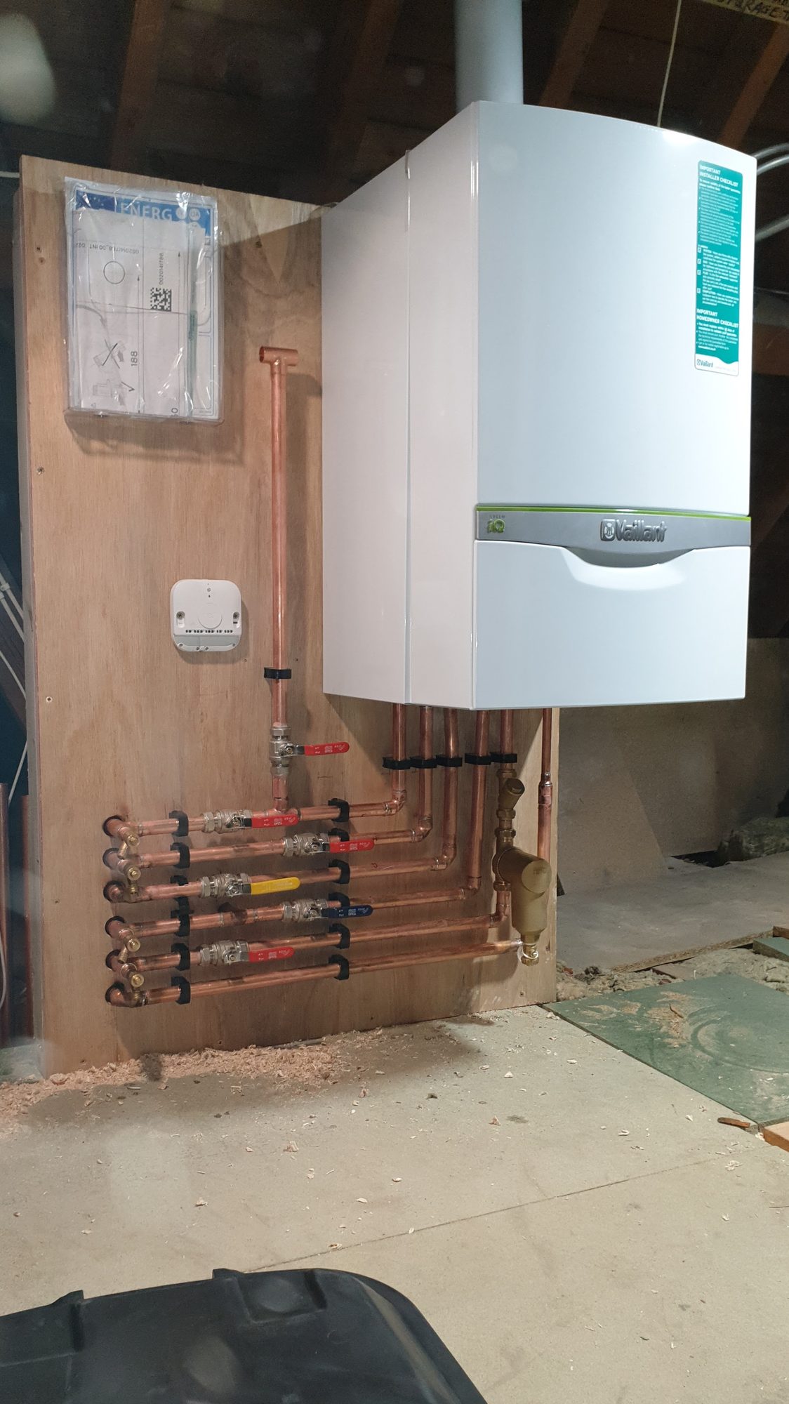 Vaillant boiler installation on a board with a labelled valve manifold and system filter