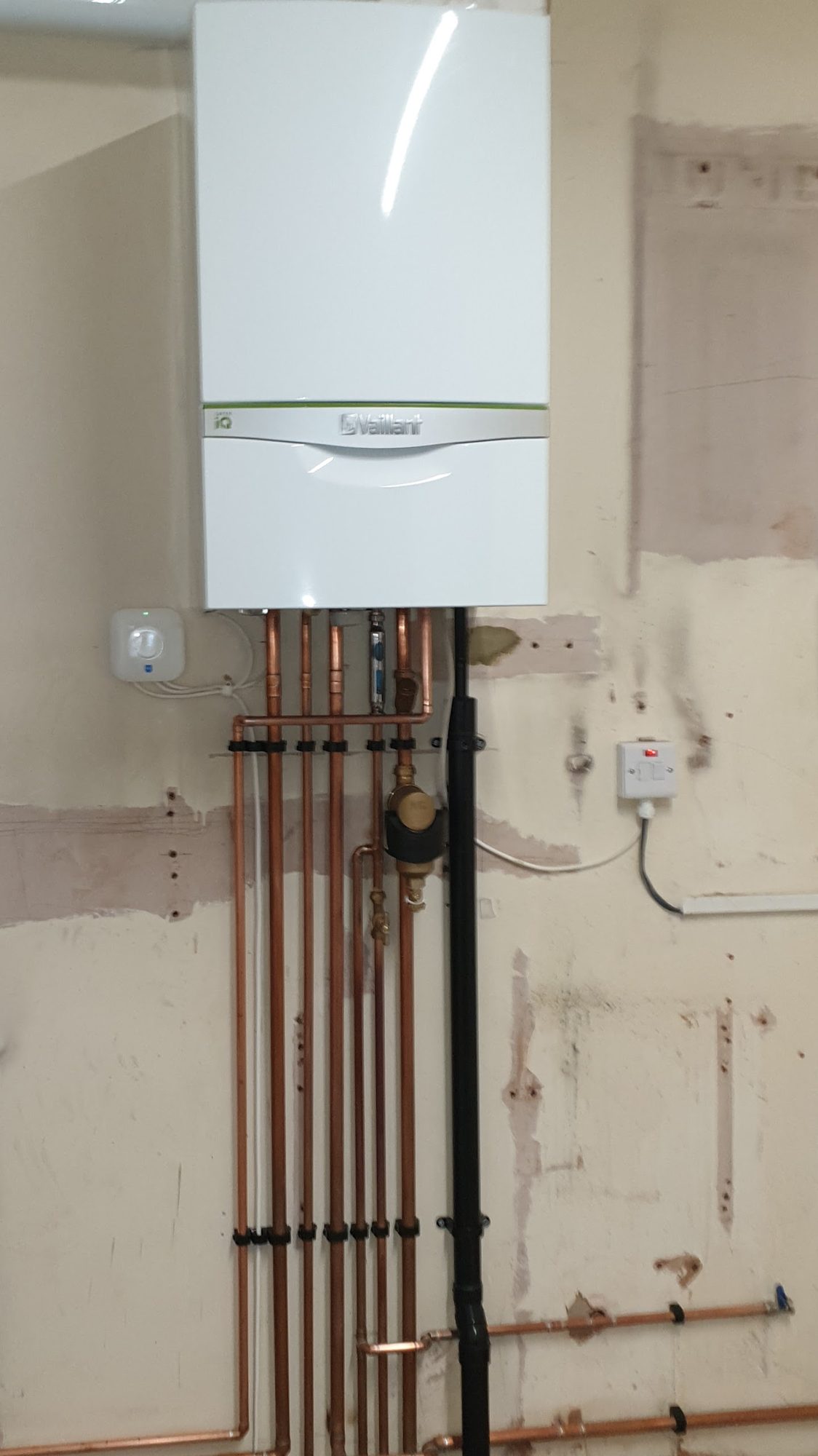 Vaillant boiler installation with clipped vertical copper pipework and gas isolation valve