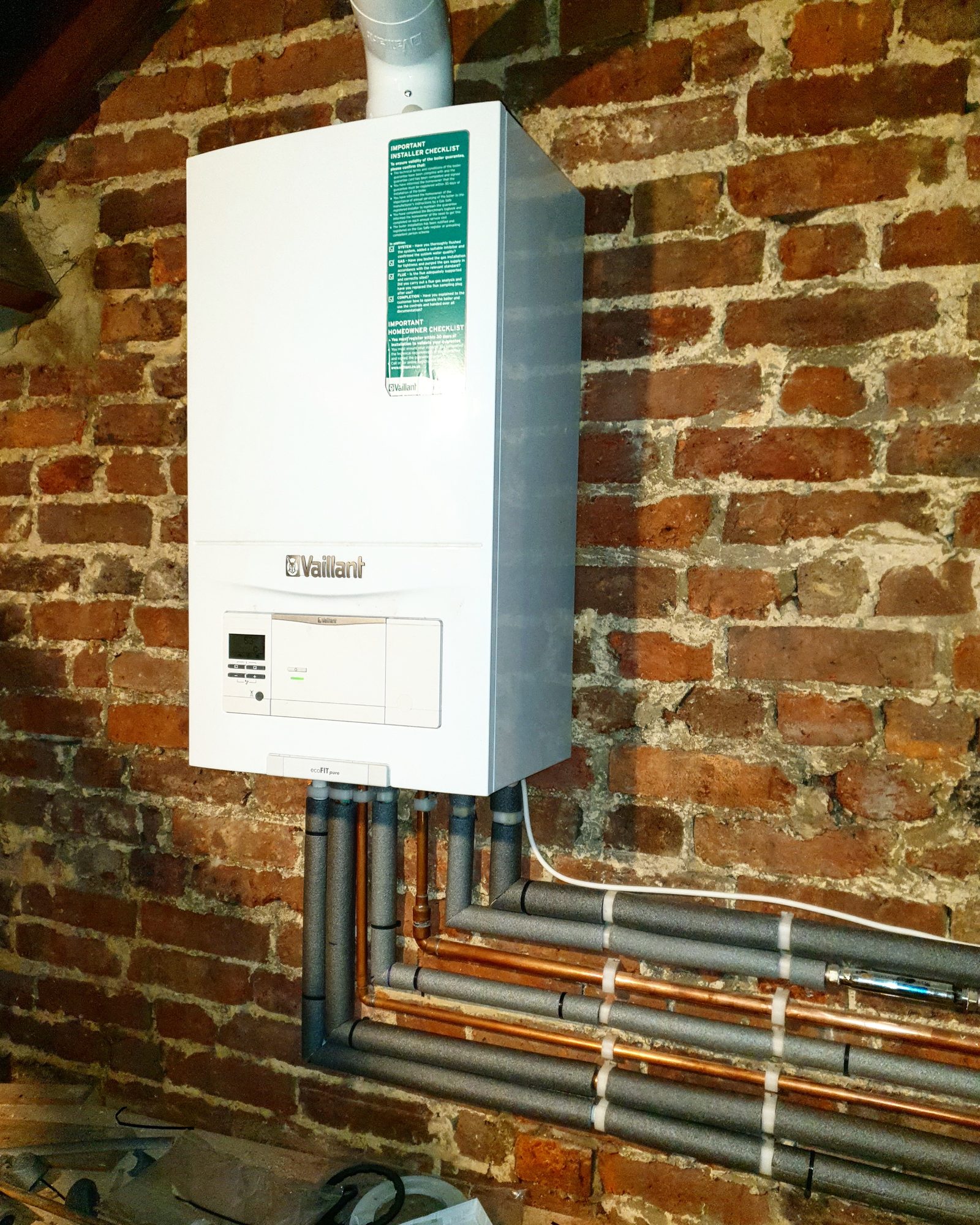Vaillant ecoFIT boiler installation on exposed brickwork with lagged copper pipework