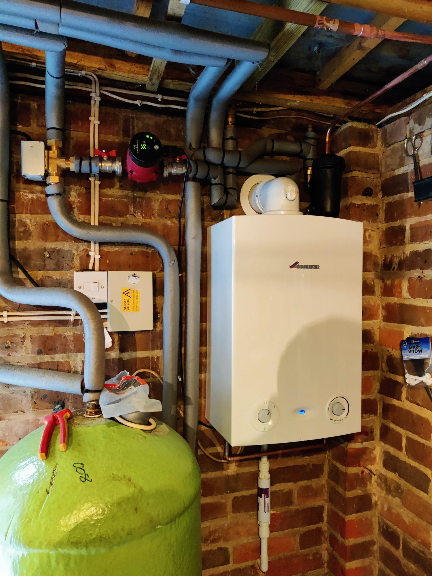 Worcester boiler installation beside an insulated hot water cylinder with new pump and heating pipework